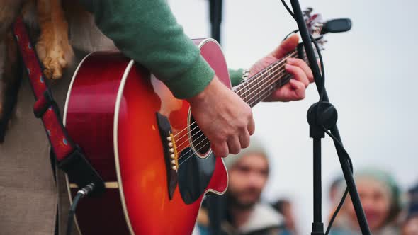 A Man Playing Guitar on Stage on the Festival