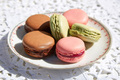 Macarons cookies with ceramic saucer and white embroidered tablecloth - PhotoDune Item for Sale