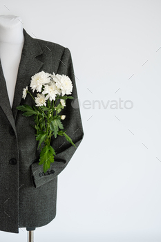 , ecology, sustainability, responsible fashion, 100 cotton. Formal Bio fabric suit with chrysanthemum flower on light background