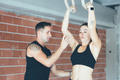 Woman_doing_deep_rings_workout_with_instructor - PhotoDune Item for Sale