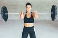 Fitness_young_woman_holds_barbell - PhotoDune Item for Sale