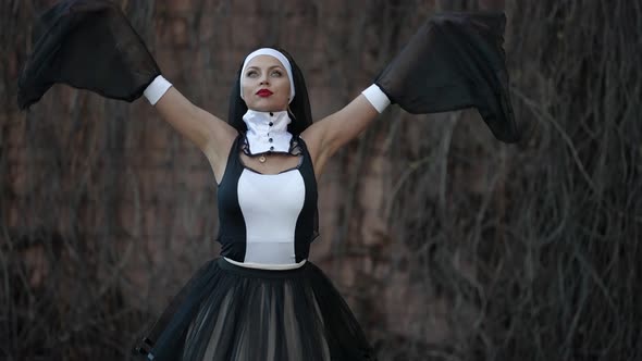 Extravagant Sexy Nun is Posing for Camera Outdoors Medium Portrait