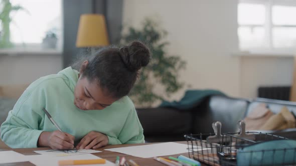 Smiling Afro Girl Drawing At Home alt