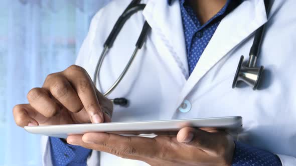 Male Physician Using Digital Tablet Close Up