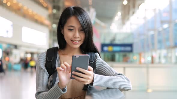 Asian Woman using cellphone in the station