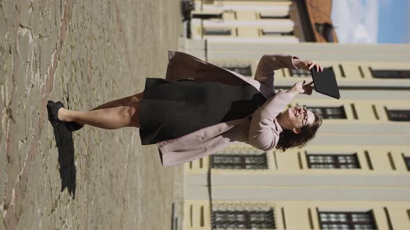 Happy Young Woman Uses Mobile Sightseeing Guide on Tablet