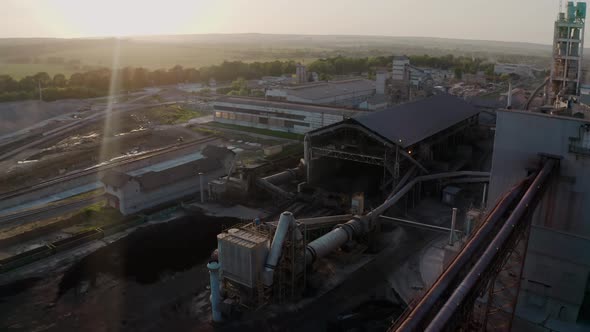 Cement Plant with High Factory Structure at Industrial Production Area at Sunset