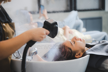 Hairdresser in beauty salon hair care in procedure of steaming water steam / Photodune, Misc