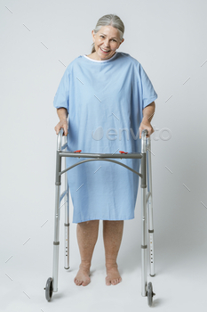 Happy patient in a hospital gown with a zimmer frame