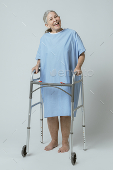 Happy patient in a hospital gown with a zimmer frame