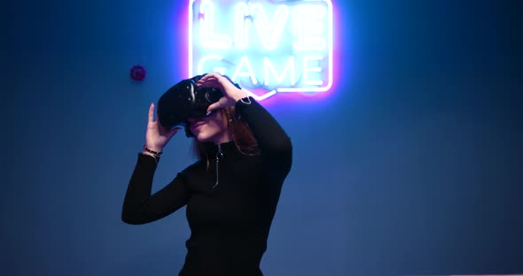 Young Woman Looks Around Virtual World Using VR