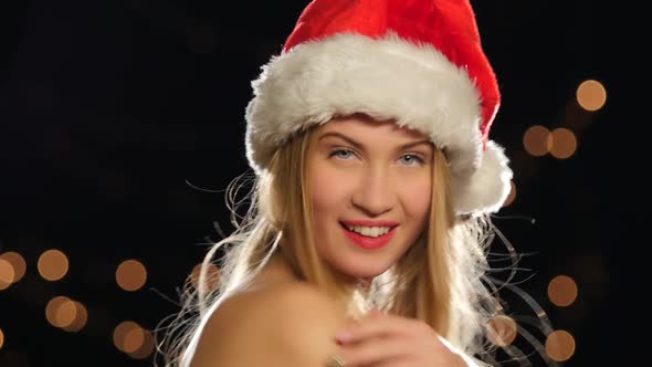 Beautiful Sexy Blonde in Christmas Cap, Isolated on Black, Сlose Up, Bokeh