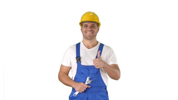 Worker with wrench showing thumb up and smiling to camera