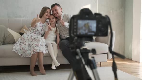 Family of Three Taking Photos with Digital Camera