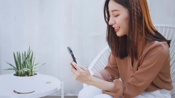 Woman Taking Picture of Plant Using Smartphone