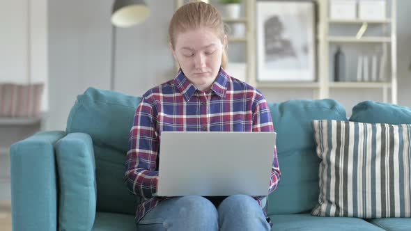 Young Woman Drowsy While Working on Laptop