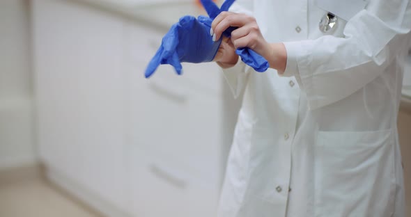 Close Up of Female Doctor Wearing Gloves