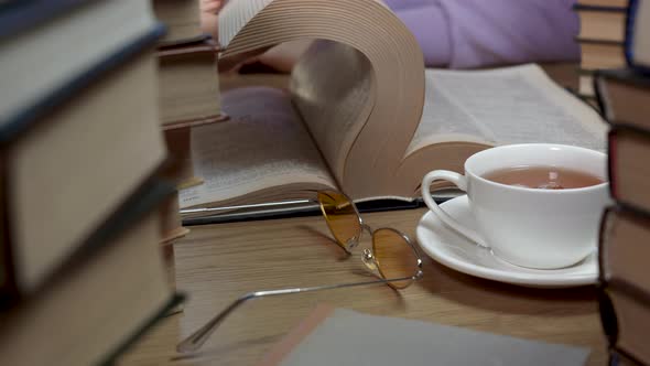 Female Hand Flipping Through the Pages of a Book Closeup