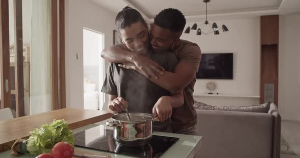 Couple Hugging and Talking During Lunch Preparation