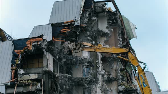 Timelapse Excavator Destroys a Building. Falling Pieces of Concrete and Rebar, Demolition Work.