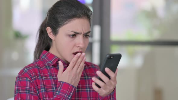 Indian Woman Reacting to Loss on Smartphone