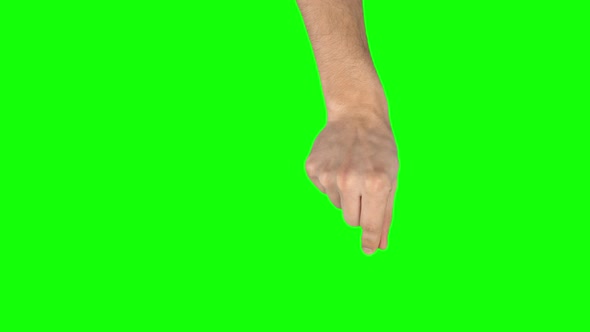 Man Hand Is Performing Pinch at Tablet Screen Gesture on Green Screen. Close Up