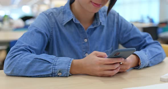 Woman use of cellphone at library