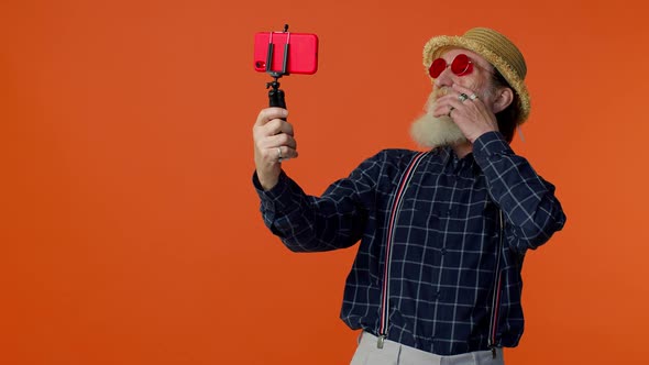 Mature Grandfather Traveler Blogger in Sunglasses Taking Selfie on Mobile Phone Video Call Online