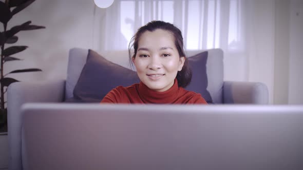 Businesswoman on redshirt using the laptop for meeting online and work from home in coronavirus