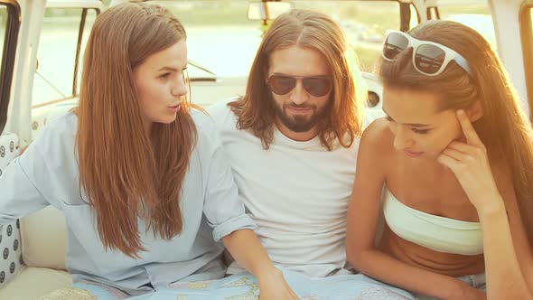 People Using Map Traveling In Summer. Smiling Happy Young Friends Using Map.