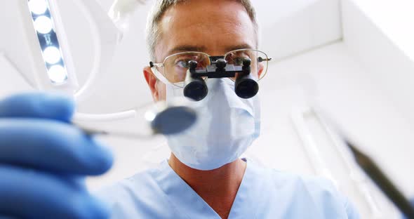 Dentist holding dental tool