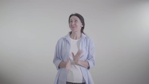 Portrait of Cheerful Adult Caucasian Woman Laughing Out Loud at White Background. Joyful Happy