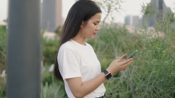 Asian teenage girls using smartphones browsing social media.