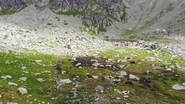 AERIAL: Slowly Flying Over Puddle of Water on the Mountain in Slovakia