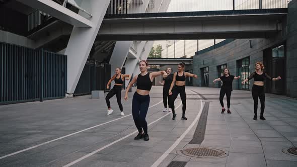 Fitness Sport Dance and Lifestyle Concept  Group of Smiling Women with Coach Dancing Outdoors