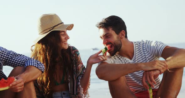 Friends having watermelon on the beach 4k