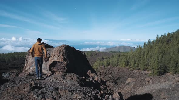 Tourist Man Climbed to the Top of a Volcanic Stone