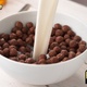 Pouring Milk into Bowl of Chocolate Ball-Shaped Cereals - VideoHive Item for Sale