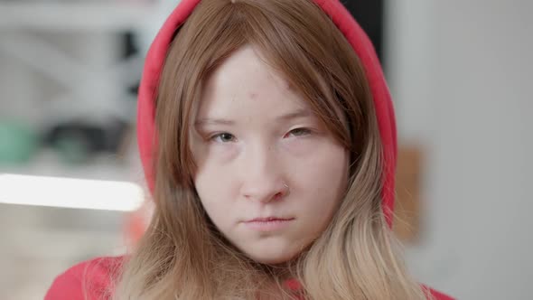 Headshot Portrait of Sad Korean Teen Girl in Hood Looking at Camera