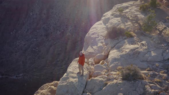 Aerial shot of a hiker at the the edge of Cedar Mesa in Utah