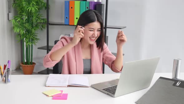 Young Asian business  woman  in office face portrait smile happy.