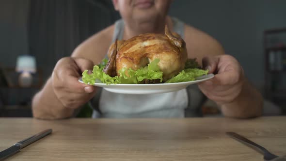 Obese Male Enjoying Tasty Smell of Grilled Chicken, Overeating and Junk Food