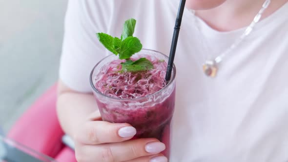 Woman Drinking Red Juice with Ice