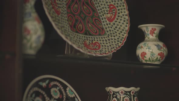 plates displayed in the window of a shop selling handmade ornamental plates