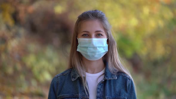 Portrait of Woman Wearing a Face Mask Against the Second Wave Quarantine Coronavirus COVID-19