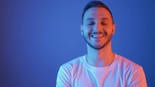 Red and Blue Studio Portrait of Smiling Football Player in White Shirt