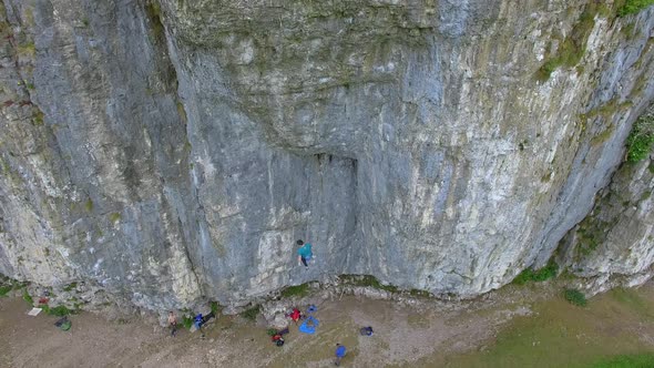 Aerial view of a man rock climbing up a mountain