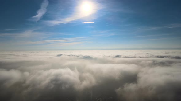 Aerial View From High Altitude of Earth Covered with White Puffy Cumulus Clouds on Sunny Day