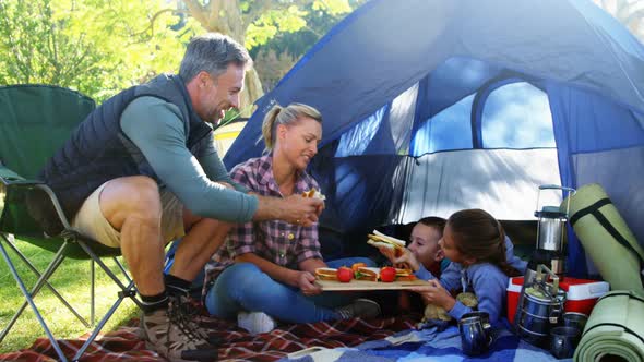 Family having snacks outside the tent