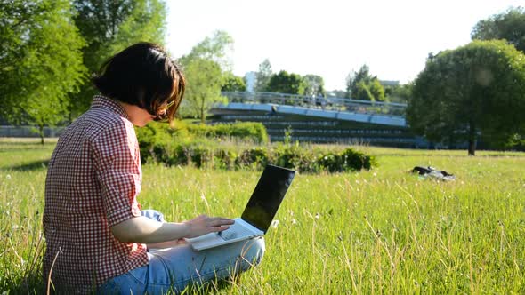 Woman Student Working on Laptop Computer in Colledge Campus